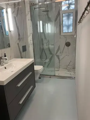 a bathroom with a shower and a sink and a toilet at Frederic - 2BR in the Historic Center in Athens