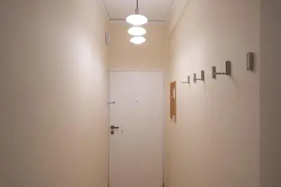 a white room with a door and lights on the wall at Frederic - 2BR in the Historic Center in Athens