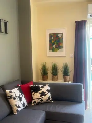 a living room with a couch and potted plants at Frederic - 2BR in the Historic Center in Athens