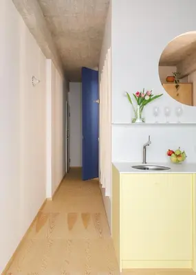 a hallway with a sink and a blue door at Apartment in Exarchia in Athens