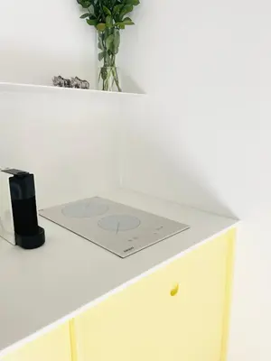 a white table with a vase on top of it at Apartment in Exarchia in Athens