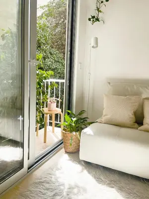 a white couch in a room with a sliding glass door at Apartment in Exarchia in Athens
