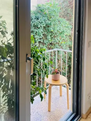 a small table on a balcony with a plant at Apartment in Exarchia in Athens