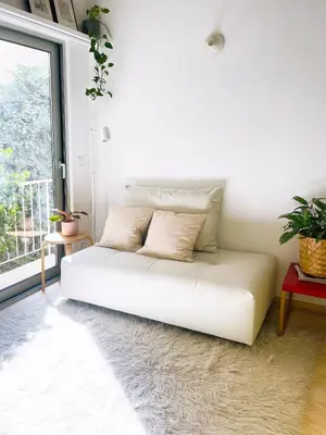 a white bed in a room with a window at Apartment in Exarchia in Athens