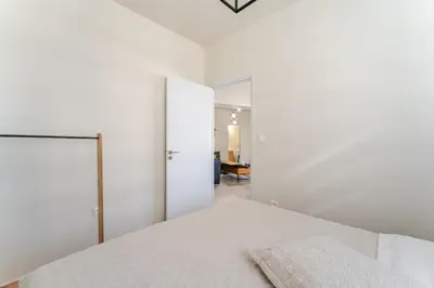 a white bedroom with a bed and a closet at Brand New Modern Stylish 6BDR 3BATH APT-Athens in Athens