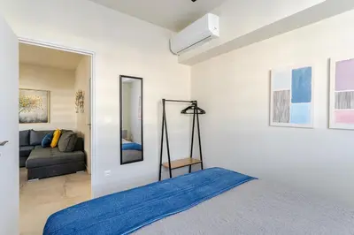 a bedroom with a bed and a couch at Brand New Modern Stylish 6BDR 3BATH APT-Athens in Athens