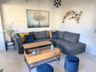 a living room with a couch and a table at Brand New Modern Stylish 6BDR 3BATH APT-Athens in Athens