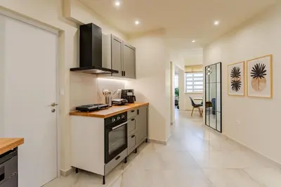 a kitchen with a stove and a counter top at Brand New Modern Stylish 6BDR 3BATH APT-Athens in Athens
