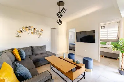 a living room with a couch and a table at Brand New Modern Stylish 6BDR 3BATH APT-Athens in Athens