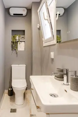 a bathroom with a white toilet and a sink at Brand New Modern Stylish 6BDR 3BATH APT-Athens in Athens