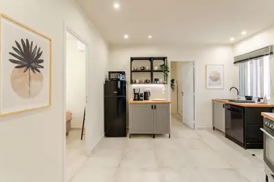 a kitchen with a black refrigerator and a counter at Brand New Modern Stylish 6BDR 3BATH APT-Athens in Athens