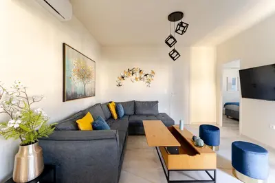 a living room with a couch and a table at Brand New Modern Stylish 6BDR 3BATH APT-Athens in Athens
