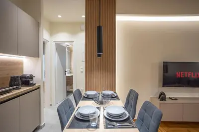 a dining room with a table and chairs in a kitchen at Cozy Luxury Apartment in Athens in Athens