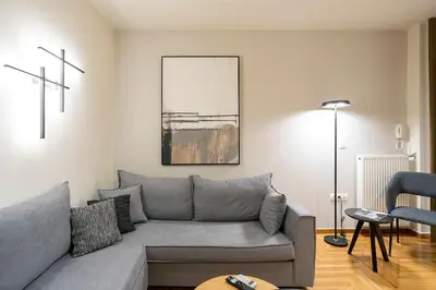 a living room with a couch and a table at Cozy Luxury Apartment in Athens in Athens