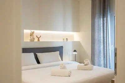 a bedroom with a bed with two towels on it at Cozy Luxury Apartment in Athens in Athens