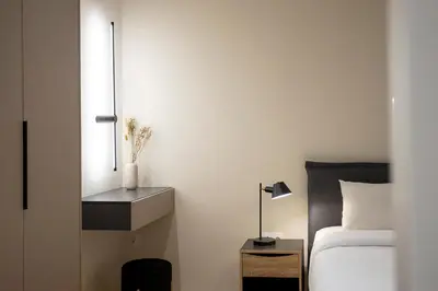 a bedroom with a bed and a night stand with a lamp at Cozy Luxury Apartment in Athens in Athens