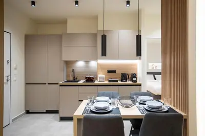 a kitchen and dining room with a table and chairs at Cozy Luxury Apartment in Athens in Athens