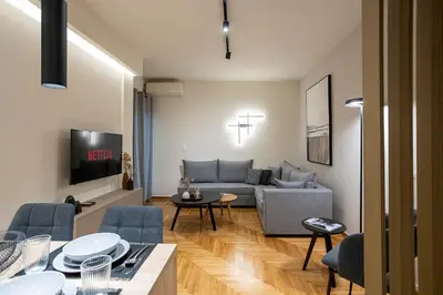 a living room with a couch and a table at Cozy Luxury Apartment in Athens in Athens