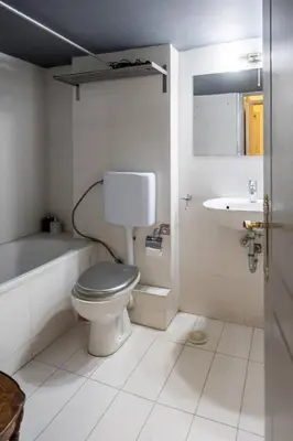 a bathroom with a toilet and a sink at Spacious and bright apt in Eksarchia in Athens