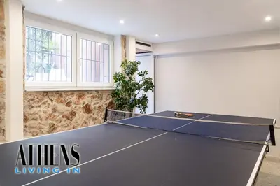 a ping pong table in a room with a ping pong table at Classic Residence A1 apt - 3ppl in Athens
