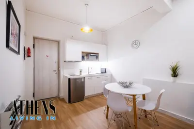 a kitchen with a table and chairs in a room at Classic Residence A3 apt 4ppl with Jacuzzi in Athens