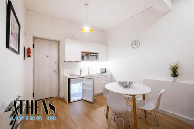 a kitchen with a table and chairs in a room at Classic Residence A3 apt 4ppl with Jacuzzi in Athens