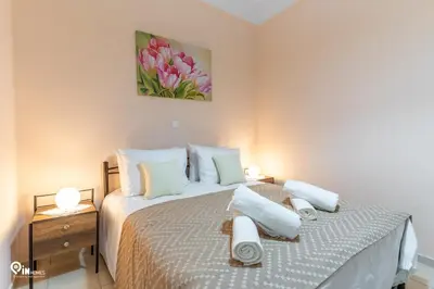 a bedroom with a bed with towels on it at Gardenia - Cozy House Near Piraeus in Piraeus