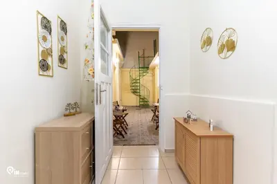 a bathroom with a sink and a hallway at Gardenia - Cozy House Near Piraeus in Piraeus