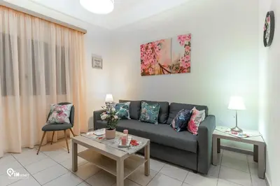 a living room with a couch and a table at Gardenia - Cozy House Near Piraeus in Piraeus