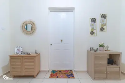a room with a white door and a table and a rug at Gardenia - Cozy House Near Piraeus in Piraeus