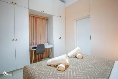 a bedroom with a bed with towels on it at Gardenia - Cozy House Near Piraeus in Piraeus