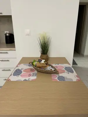 a table with a bowl of fruit and a plant on it at Jimilio 1 in Spáta