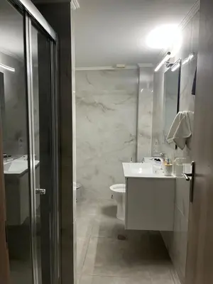 a bathroom with a sink and a toilet at Jimilio 1 in Spáta