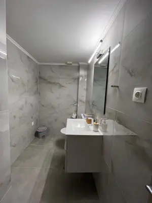 a white bathroom with a sink and a mirror at Jimilio 1 in Spáta