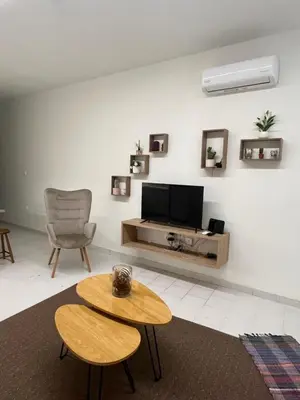 a living room with a tv and a table at Jimilio 1 in Spáta