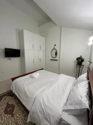 a bedroom with a large bed with white sheets at Jimilio 1 in Spáta