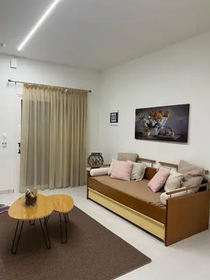 a living room with a bed and a table at Jimilio 1 in Spáta