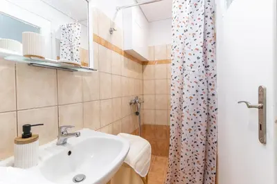 a bathroom with a sink and a shower at Orchid - Stylish Home Near Piraeus in Piraeus