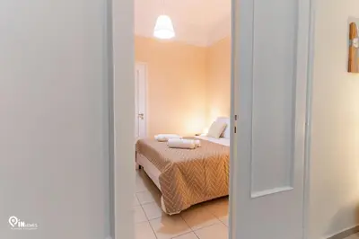 a bedroom with a bed in a room at Orchid - Stylish Home Near Piraeus in Piraeus
