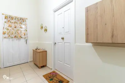 a bathroom with a white door and a small cabinet at Orchid - Stylish Home Near Piraeus in Piraeus