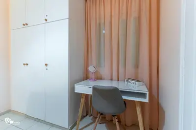 a desk with a chair and a lamp in a room at Orchid - Stylish Home Near Piraeus in Piraeus