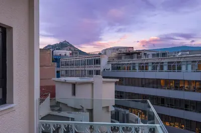 a view of a city from a balcony of a building at Sofokleous suite with Acropolis stunning view in Athens