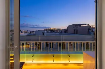 a view of a city from a window at Sofokleous suite with Acropolis stunning view in Athens