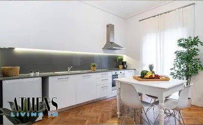 a kitchen with white cabinets and a table with fruit on it at Classic Studio B1 - 3ppl in Athens