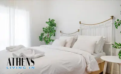 a white bedroom with a white bed with white pillows at Classic Studio B1 - 3ppl in Athens
