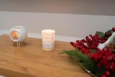 a candle on a table next to a bunch of berries at Modern Niarchos Escape in Athens