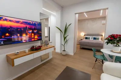 a living room with a large tv on a wall at Modern Niarchos Escape in Athens