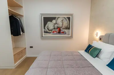 a bedroom with a bed and a painting on the wall at Modern Niarchos Escape in Athens
