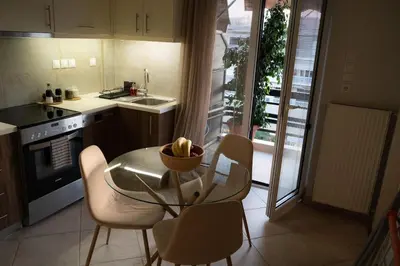 a kitchen with a glass table and chairs and a sink at Bright Gem in Vibrant Popular Neighborhood in Athens
