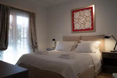 a bedroom with a white bed with towels on it at Bright Gem in Vibrant Popular Neighborhood in Athens